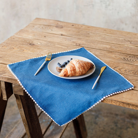 Pom pom trim linen napkin in blue color