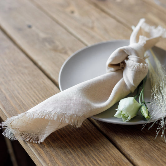 Fringed linen napkin in beige color