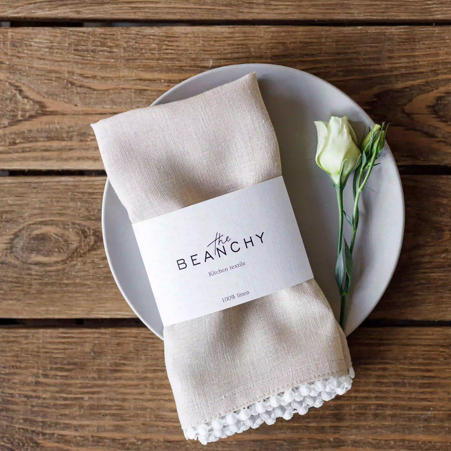 Pom pom trim linen napkin in beige color