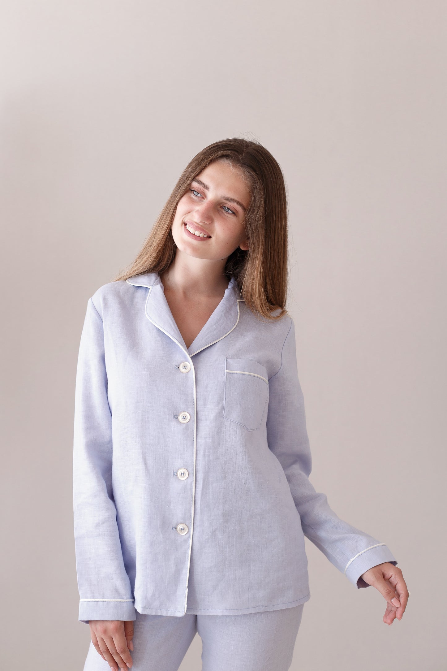 Close-up of sky blue linen pajama top with collar, buttons, and pocket